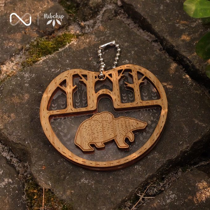 bear father and son wooden keychain on ground