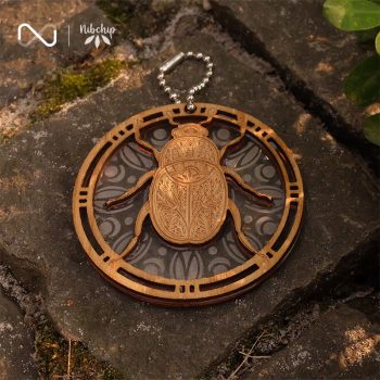 water bug wooden keychain on ground