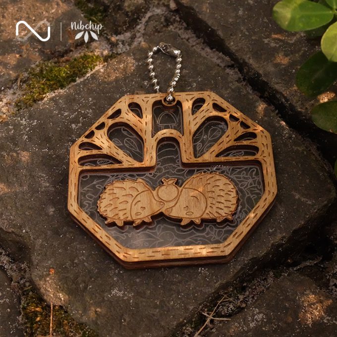 twin hedgehogs wooden keychain on ground