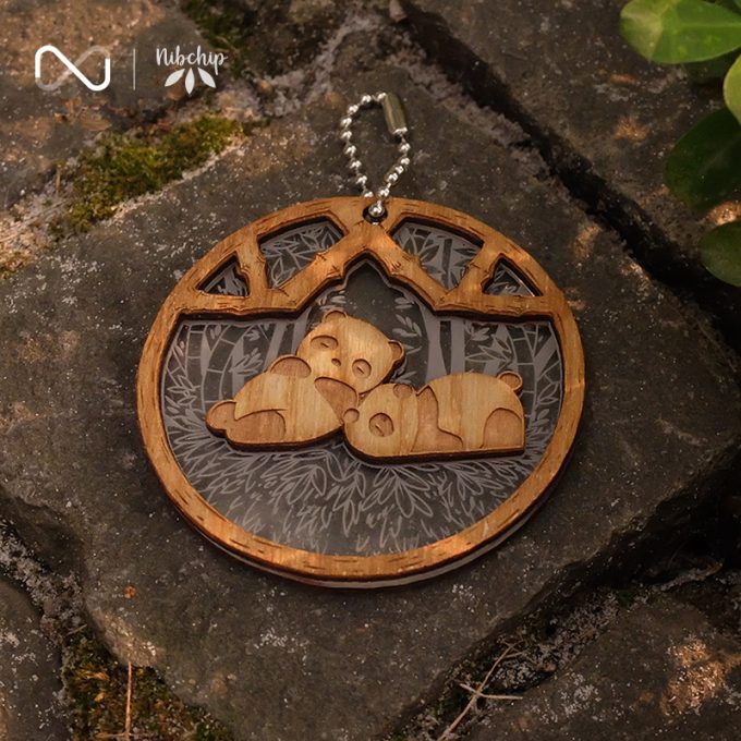 panda brothers wooden keychain on ground