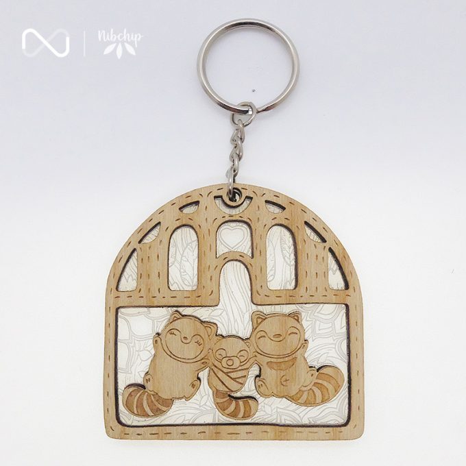 racoon family wooden keychain front